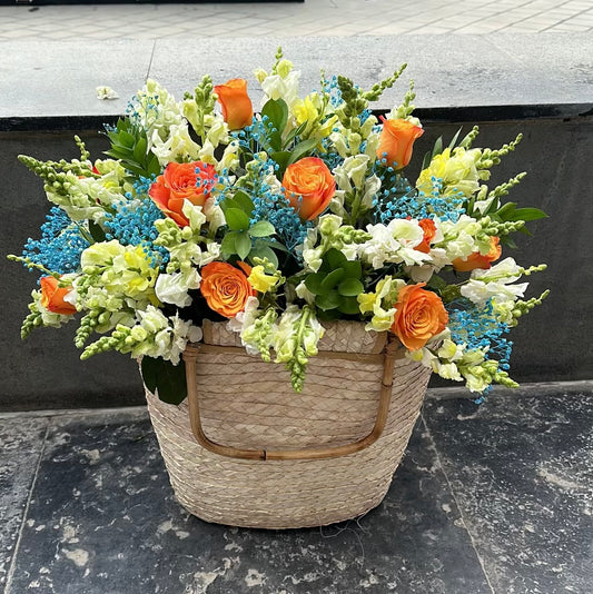 Orange Basket with Blue Baby Flowers